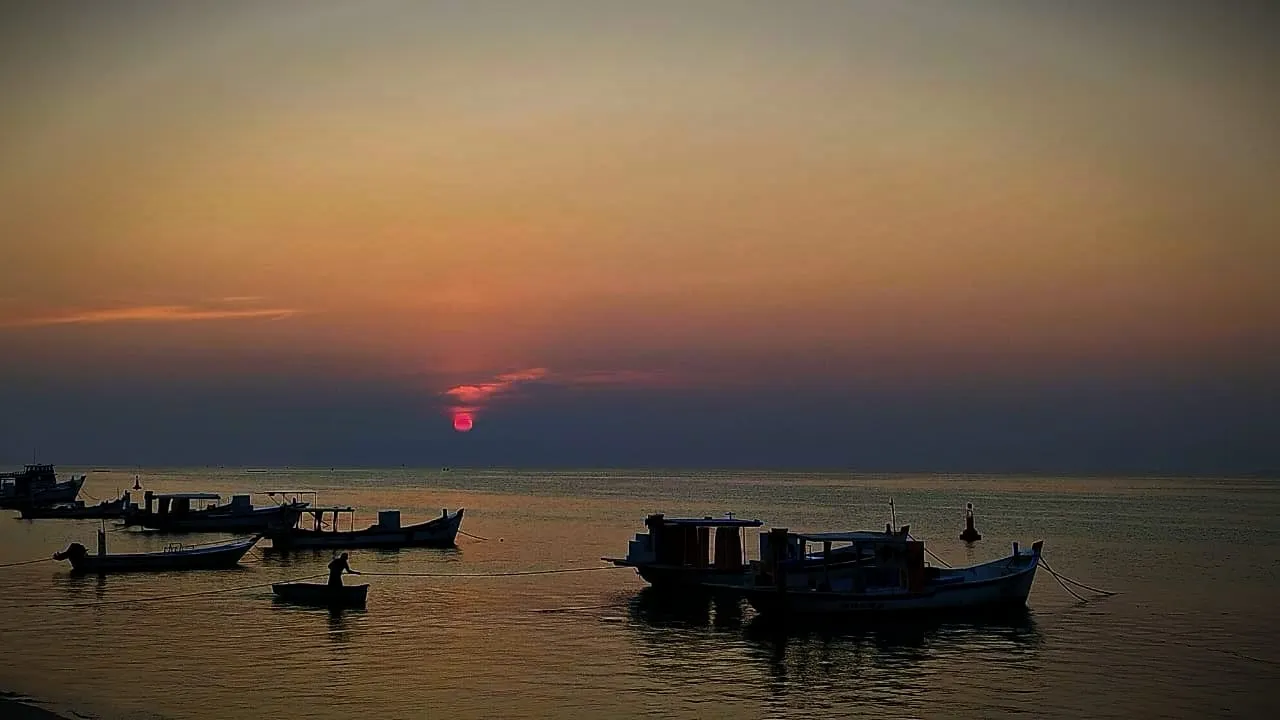 Fishing boats on the lagoon at sunset